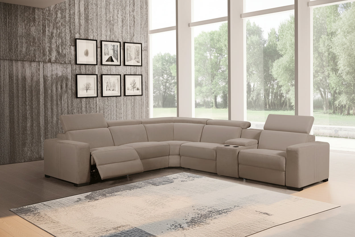 Gray sectional sofa in a living room with large windows and decorative wall art.