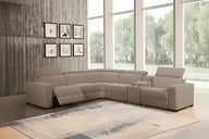 Gray sectional sofa in a living room with large windows and decorative wall art.